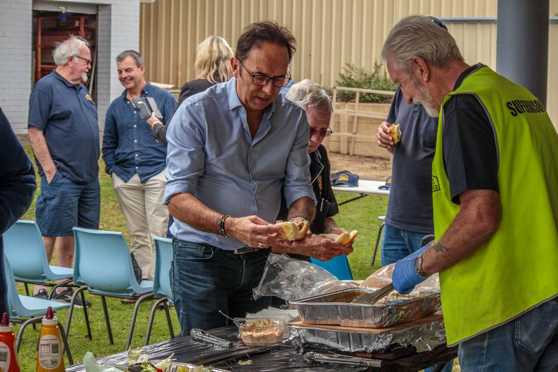 Councillor Karlo Perkov being served a beef roll by Terry Sheard at the 2023 Annual General Meeting